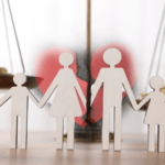 Silhueta de papel de uma família unida à frente de uma balança da justiça equilibrada com moedas, representando a equidade no Direito de Família.